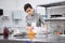 A bright pastry chef girl is engaged in the preparation of a cake