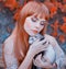 Bright photo, red-haired girl with straight hair and bangs holds cute sleeping ferret in her hands, lady with closed