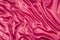 Bright pink, cerise silk folded fabric background