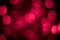Bright pink defocus lights on a black background. Abstract bokeh background. Valentine`s Day