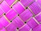 Bright pink texture squares in a wicker basket background