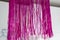 Bright pink tinsel fextive christmas deco. merry christmas and happy new year. christmas tree decoration. xmas time. retro new