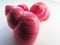 Bright pink vibrant twisted glossy shiny snail shells composition lens isolated on a white background.