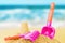 Bright plastic children`s toys in the sand. Concept of beach recreation for children. Children`s summer games. Summer concept