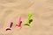 Bright plastic shovels in sand, space for text. Beach toys