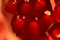 Bright pomegranate seeds closeup, red in red light