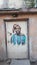 bright portrait of the African woman on an ordinary-looking door of the old house