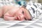 Bright portrait of cute 14 days newborn baby boy in funny cap lying and looking around