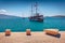 Bright postcard of wooden ships on the shore of Saranda port.