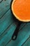 Bright pumpkin pie in cast iron pan on turquoise background mini