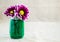 Bright purple argyranthemum flowers in a small mason jar