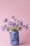 Bright purple chamomile wildflowers on a pink background. summer spring simple bouquet. vertical photo