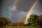 Bright rainbow after the rain on a farm land, West Sussex, UK.