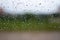 Bright raindrops on car glass, evening after work, in the parking, take close-up a photo,  Soil and grass background blur, image