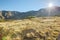 Bright rays of sunlight shining above autumn mountains