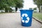 Bright recycle bin with label on the road without people. Concept of envirometal protection. Cleaned outside terrain.