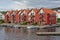 Bright red apartment buildings with Yachts moored in front