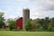 A bright red barn and silo on a farm in rural Illinois.