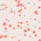 Bright red, blue, orange messy dots on beige background. Festive seamless pattern with round shapes.