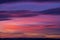 Bright red-blue-orange sunset in the sky with clouds. Beautiful colorful dawn above the earth. Artistically blurry.