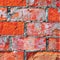 Bright red brick wall texture macro closeup, old detailed rough grunge cracked textured bricks copy space background, grungy