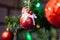 Bright red Christmas toys on the branches of an artificial Christmas tree. Snow balls and berries. A variety of festive accessorie