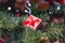 Bright red Christmas toys on the branches of an artificial Christmas tree. Snow balls and berries. A variety of festive accessorie