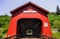 Bright red covered bridge