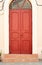 Bright red door and strairs outdoors on the street