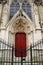 Bright red doors in beautiful stone,with locked gates in front,Notre Dame Cathedral,Paris,France,2016