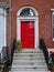 bright red front door of old townhouse