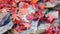 Bright red japanese maple leaves scattered over a pile of rocks.