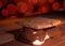 Bright red lights out of focus behind a large smore