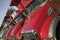 Bright red Mack dump trucks line the road in a row, in Maine near the New Hampshire border