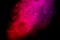 Bright red and pink smoke isolated on black background