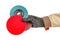 Bright red polishing disc with blue abrasive flap disc and sanding paper disc in worker hand in black protective glove and brown