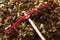 Bright red rake resting on a heap of freshly raked autumn leaves