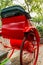 A bright red rickshaw in a back alley in a Beijing hutong - 3
