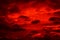 Bright red sunset. Dramatic evening sky with clouds. Fiery skies with space for design. Magic fantasy sky.