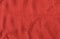 Bright red texture of binding fabric. Red textile background with natural folds. Close-up