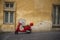 Bright red Vespa scooter in an urban street