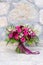 Bright red wedding bouquet on the stone wall background