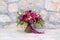 Bright red wedding bouquet on the stone wall background
