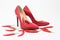 Bright red women`s stiletto heels. There are chili peppers nearby. Nice combination of shoes and pepper. Red color