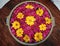 Bright red and yellow coloured flowers arranged for display in Lalitha Mahal Palace, Mysore