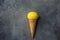 Bright Ripe Yellow Lemon in Waffle Ice Cream Cone on Dark Concrete Stone Background. Summer Fruits Dessert Freshness Vitamins