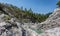 Bright rocks in narrow valley of mountain stream