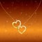Bright romantic background with two golden hearts.