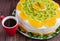 Bright round festive fruit cake decorated with kiwi, orange, mint