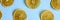 bright round sliced pieces of dried jerky oranges on a contrasting blue background, repeating pattern. flat lay, top view. banner.